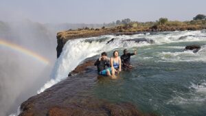 Visitors swimming at Devil’s Pool, Victoria Falls